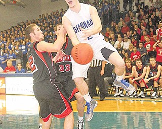 Poland’s Anthony Machi (2) swats the ball away from Canfi eld defenders P.J. Stickle (2) and Jake Ferrier (33) during an All-American Conference Red Tier basketball game Friday at Poland High School. The Bulldogs won 50-41 to give coach Ken Grisdale his 300th career victory.