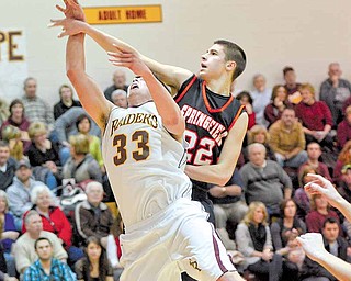 South Range junior Dan Good is fouled by Springfield junior Nick Russell.