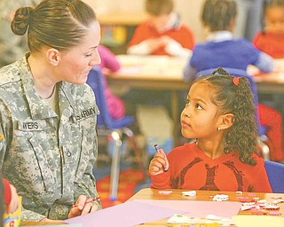 Jessica Myers from Youngstown State University’s Armed Forces Student Association and Gianna Zamudio, a kindergarten student at Zion Christian School at Zion Lutheran Church in Youngstown, share a quiet moment while creating Valentine’s Day cards to be sent to troops in Afghanistan. George McDonnell, a local business leader, has been instrumental in providing connections for delivery of the valentines. The event was sponsored by Shepherd of the Valley Home Health.