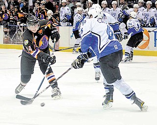 Youngstown Phantom Mike Ambrosia and the Lincoln Stars' Chris Casto fight for possession of the puck.