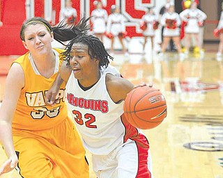 Youngstown Penguin Tieara Jones drives to the hoop and is defended by Valparaiso's Maegan Callaway.
