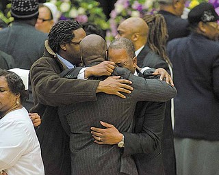 Mourners of the death of Jamail Johnson comfort one another at his funeral service held at YSU's Beeghly Center Saturday morning. Johnson, a YSU senior, was killed in a shooting early February 6 at his residence north of the YSU campus. 11 people, including six YSU students, were wounded.