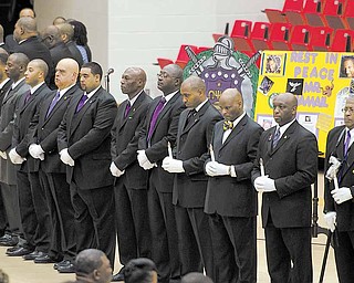 Members of the Omega Psi Phi fraternity gather during Jamail Johnson's calling hours Saturday morning at YSU's Beeghly Center.