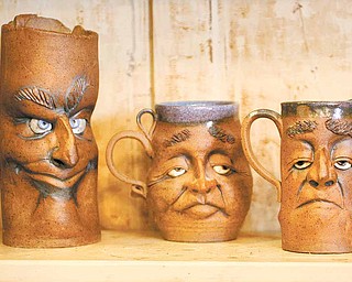 "Monday Morning Clay Mugs" by Jim Lutz of New Castle grace the shelf at 29 Logan Ave., "A Little Gallery on the West Hill." The gallery, just west of downtown Sharon, is a mecca for handmade art deco, all made by the talented area artists.