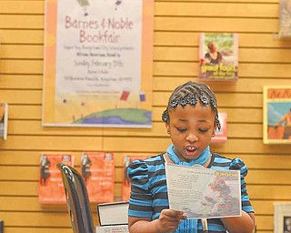 A'Mya Moody, a second-grader from Paul C. Bunn Elementary, reads a selection called "Books" during the African American Read-In held by the Youngstown City Schools at Barnes & Noble Booksellers in Boardman.