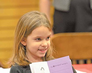 Kaylee Cerbus, a kindergartener from Paul C. Bunn Elementary, reads "Making a Peanut Butter & Jelly Sandwich" during the African American Read-In held by the Youngstown City Schools at Barnes & Noble Booksellers in Boardman.