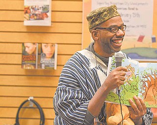 Roland C. Barksdale-Hall reads a selection from his book "Under African Skies" during the African American Read-In held by the Youngstown City Schools at Barnes & Noble Booksellers in Boardman.