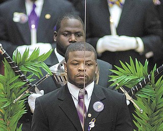 Members of the Omega Psi Phi fraternity gather during Jamail Johnson's calling hours Saturday morning at YSU's Beeghly Center.