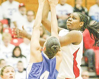 YSU's Brandi Brown shoots over IPFW's Stephanie Rosado during first half action Saturday at YSU.