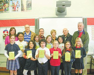 Never at a loss for words: Struthers Rotary Club is continuing its participation in the Dictionary Project by delivering dictionaries to fourth-grade students in area schools. The goal of the program is to assist all students in becoming good writers, active readers, creative thinkers and resourceful learners. The dictionaries are given as gifts for each student to use at school and at home. Joining the fourth-grade students at St. Nicholas School, Struthers, as they display their new dictionaries are, from left at back, Taylor Hair, fourth-grade teacher; and Tom Baringer, Bryan Higgins, Marge Diorio, Paul Paris and Dan Becker, Rotary members.
