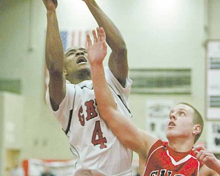 Will Clark of Struthers, left, shoots around Salem’s Taylor Fredrickson during Tuesday’s game at Struthers.