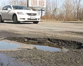 Potholes such as this one in the 1400 block of South Avenue are easy to spot during the day but can be masked in puddles and during night travel. They can cause damage a vehicle’s tires, alignment and suspension.