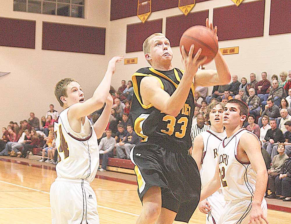 Tom Oliver (33) drives past Mike Thorpe (22) and Isaac Schuster (44) of South Range during their game Wednesday night.