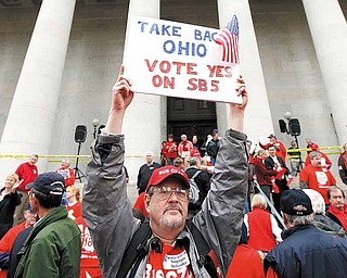 Richard Ringo, a members of The Ohio Liberty Council, a coalition of over 60 tea party groups and liberty minded organizations across Ohio, holds a sign in support of Senate Bill 5, at the Ohio Statehouse Thursday, Feb 17, 2011, in Columbus, Ohio. (AP Photo/Terry Gilliam)
