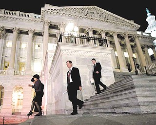 Congressmen walk down the steps of the House of Representatives as they work throughout the night on a spending bill, on Capitol Hill in Washington, Friday, Feb. 18, 2011 