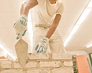 Russell Gibson, an 11th grader from Chaney, works on building a wall as part of a contest for tech students in Ohio.