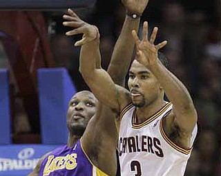 Cleveland Cavaliers' Ramon Sessions (3) passes the ball under pressure from Los Angeles Lakers' Lamar Odom (7) in the fourth quarter of an NBA basketball game in Cleveland on Wednesday, Feb. 16, 2011. The Cavaliers won 104-99. 