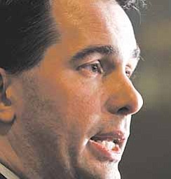 Wisconsin Gov. Scott Walker talks to the media Thursday, Feb. 17, 2011, at the State Capitol in Madison, Wis., in response to 14 state Senators leaving the state to block his bill that would eliminate collective bargaining rights for many state workers.