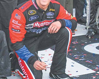 Trevor Bayne signs his name into cement in Victory Lane after winning the Daytona 500 at Daytona International Speedway in Daytona Beach, Florida, Sunday, February 20, 2011.