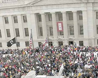 Protesters gather at the Ohio Statehouse to voice their opposition to Senate Bill 5 on Tuesday, Feb. 22, 2011 in Columbus, Ohio. Officials have locked the doors to the Ohio Statehouse as thousands of union protesters gather on the grounds to oppose the bill that would strip public employees of collective bargaining rights. Ohio Public Safety spokesman Joe Andrews says about 1,000 people have been allowed into the Rotunda and Atrium for the committee hearing on the bill. Additional visitors are being directed to an off-site theater, where the meeting will be simulcast.