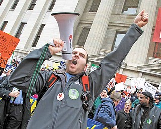 Jason Petroff, of Chardon, leads cheers during a protest against Senate Bill 5 outside the Ohio Statehouse, Tuesday, Feb. 22, 2011, in Columbus, Ohio.