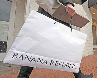 In this Feb. 14, 2011 photo, a shopper carries her purchases in the Shadyside section of Pittsburgh. The Consumer Confidence Index rose in February to its highest point in three years as consumers are feeling more positive about their income prospects and the direction the economy is headed.