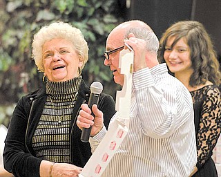 Joseph Seminara of the local Pizza Joe’s restaurant chain announces that Barb Kuras of Boardman, left, won a year’s worth of pizza at the Thrill or No Thrill fundraiser for the United Way of Youngstown and the Mahoning Valley. Seminara was the master of ceremonies for Wednesday’s fundraiser, based on the TV show “Deal or No Deal,” at Our Lady of Mount Carmel hall in Youngstown.