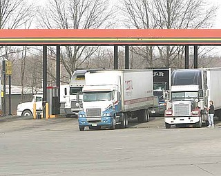Diesel prices have been increasing. Trucks fill up at the pumps.