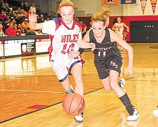 Struthers' Katelyn Ardale battles Samii Ramer (10) for the ball during their game Wednesday night in Austintown.