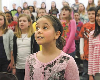 Fifth-grader Alexis Bodnar sings along with classmates during choir practice at Frank Ohl Intermediate School in Austintown. The students will perform the national anthem Friday before the Youngstown Phantoms hockey game at the Covelli Centre in downtown Youngstown.