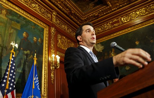 Wisconsin Gov. Scott Walker talks to the media at the state Capitol in Madison, Wis., Wednesday, Feb. 23, 2011. Opponents to the governor's proposal to eliminate collective bargaining rights for many state workers are in their ninth day of protests at the Capitol.  (AP Photo/Andy Manis)