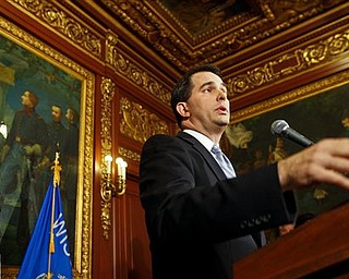 Wisconsin Gov. Scott Walker talks to the media at the state Capitol in Madison, Wis., Wednesday, Feb. 23, 2011. Opponents to the governor's proposal to eliminate collective bargaining rights for many state workers are in their ninth day of protests at the Capitol. (AP Photo/Andy Manis)