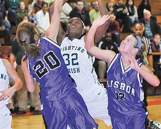 Ursuline's Courtney Powell muscles her way between Lisbon defenders #20 Anna Dunn and #12 Julie Gauntt, while on her way to the basket.