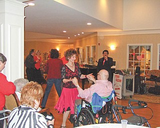 Time for a dance: “Let Me Call You Sweetheart” was the theme for a Valentine’s Day dance at Victoria House Assisted Living Facility, 5295 Ashley Circle, Austintown, where the grand lobby was transformed into “Club Victoria.” After residents were treated to a surf-and-turf dinner, music was provided by Steve Fazzini as special guests and a group of ballroom dancers entertained and danced with the residents. Joining in the festivity, above, was Rosemary Yaworsky, a nurse at Victoria House, whose dance partner is one of the residents, Jack Finn.