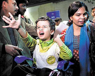An Indian family who were in Libya arrive after being evacuated from Tripoli, because of the ongoing strife, at Indira Gandhi International airport, in New Delhi, India, Sunday, Feb. 27, 2011. The first batch of nearly 300 Indians evacuated from strife-torn Libya landed in New Delhi aboard a special Air India flight close to midnight Saturday. Meanwhile, three Indian Navy ships have also sailed to Libya to help in the evacuation of the 18,000 Indians in the country, according to news reports.