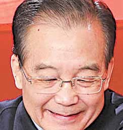 In this photo released by China's Xinhua news agency, Chinese Premier Wen Jiabao, left, prepares to hold an online chat with Internet users at two state news portals in Beijing, on Sunday Feb. 27, 2011.
