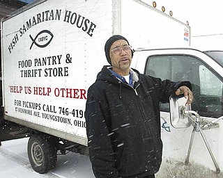 Clarence Thigpen, director of Fish Samaritan House in Youngstown, stands next to the agency's 1999 Chevrolet 3500. The truck has more than 172, 000 miles and is on its last leg.
