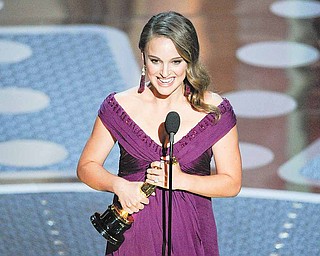 Natalie Portman accepts the Oscar for best performance by an actress in a leading role for "Black Swan" at the 83rd Academy Awards on Sunday, Feb. 27, 2011, in the Hollywood section of Los Angeles.