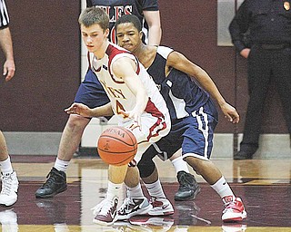Mooney's Danny Reese (24) tries to keep the ball from Ray Russ (4) during their game Monday night in Boardman. 