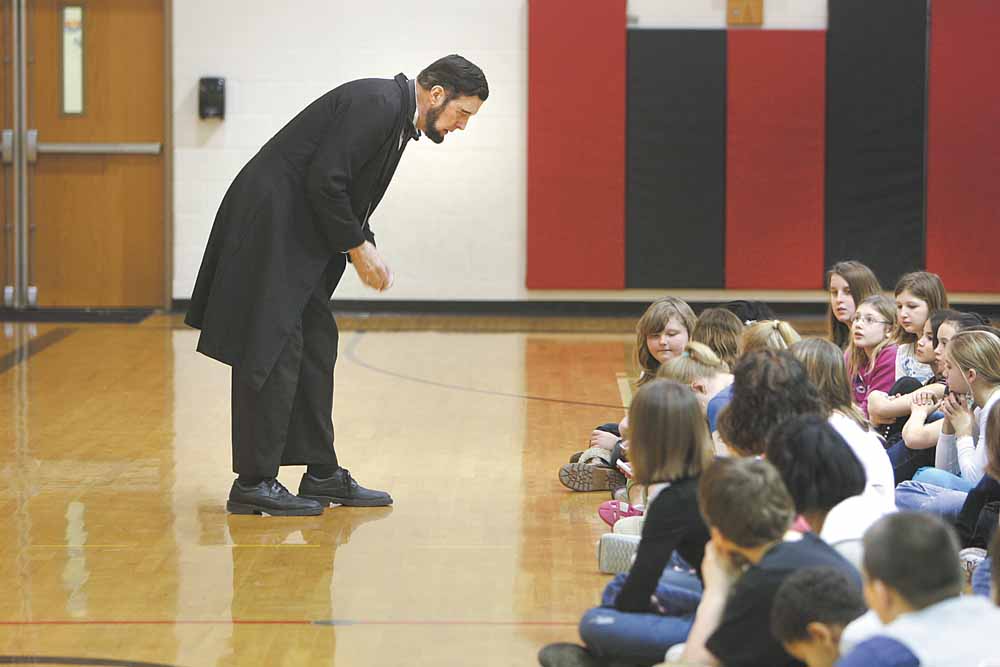 Abraham Lincoln, as portrayed by Gerald Payn of Wooster, engages fifth-graders at Girard Intermediate School during a presentation Monday. Greg Bonamase, principal, said the enrichment program “is designed to bring history alive.”