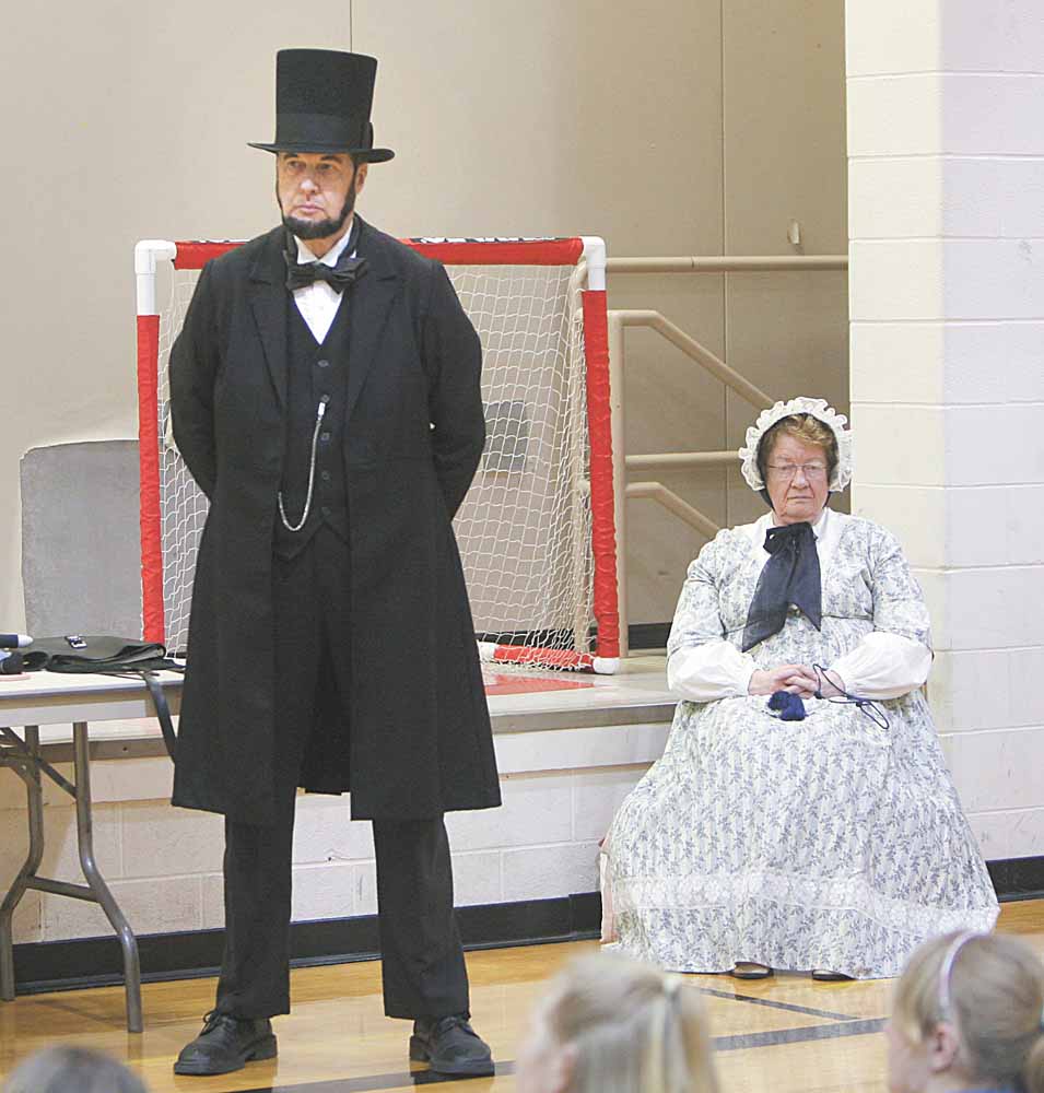Gerald Payn looks the part of Abraham Lincoln dressed in a long black suit coat and trousers along with the trademark top hat. His wife, Marilyn, plays the part of Lincoln’s spouse, Mary Todd. Payn portrayed the 16th president for students at Girard Intermediate School Monday.