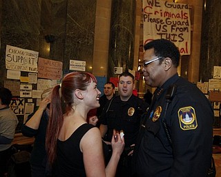 Wisconsin Capitol Police Chief Charles Tubbs, right, talks to a protester at the state Capitol in Madison, Wis., Sunday, Feb. 27, 2011, after it was announced the demonstrators will be to stay another night at the Capitol. Opponents to the governor's bill to eliminate collective bargaining rights for many state workers have been demonstrating for 13 days. 