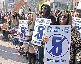 Frances Turnage, left, Marilyn Moore and Peggy Campbell were among about 200 United Auto Workers members from the General Motors Lordstown complex who traveled to Columbus on Tuesday to protest proposed changes to the state's collective-bargaining laws. Senate Bill 5 would limit bargaining for state and local public workers throughout Ohio.