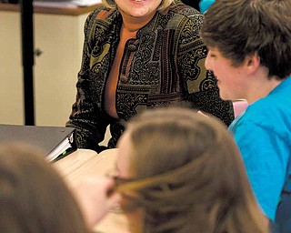 Eva Sullivan chats with students during class Tuesday. The literary circles students participate in spark more interest in reading, Poland teachers have found.