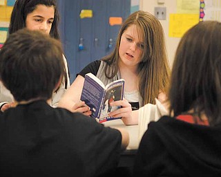 Jessica Weetman, 12, looks through her copy of “Freak the Mighty,” by Rodman Philbrick during a literature circle Tuesday afternoon. Students say they like having the option to choose what they read in class.
