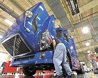 In this Jan. 26, 2011 photo, a worker does a final inspection of a truck on the Volvo assembly line at the plant in Dublin, Va. U.S. manufacturers expanded at the fastest pace in nearly 7 years last month, a sign that factories are still leading the economic recovery. (AP Photo/Steve Helber)