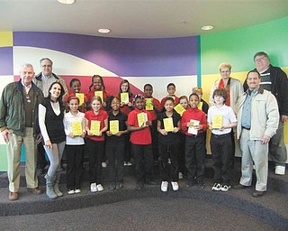 Words to the wise: In a continuing effort to assist students in becoming good writers, active readers, creative thinkers and resourceful learners, Struthers Rotary recently presented dictionaries to fourth-grade students at Campbell Elementary School. Annette Tovarnak, front row left, joins members of her class as they display the gift books they received from Rotary members, from left, Dan Becker, Tom Baringer, Alice Cashbaugh, Mike Evanson and Bryan Higgins.