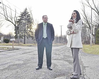Sherry Froelich discusses the condition of Webb Road in front of her home with Austintown Township Trustee Jim Davis.