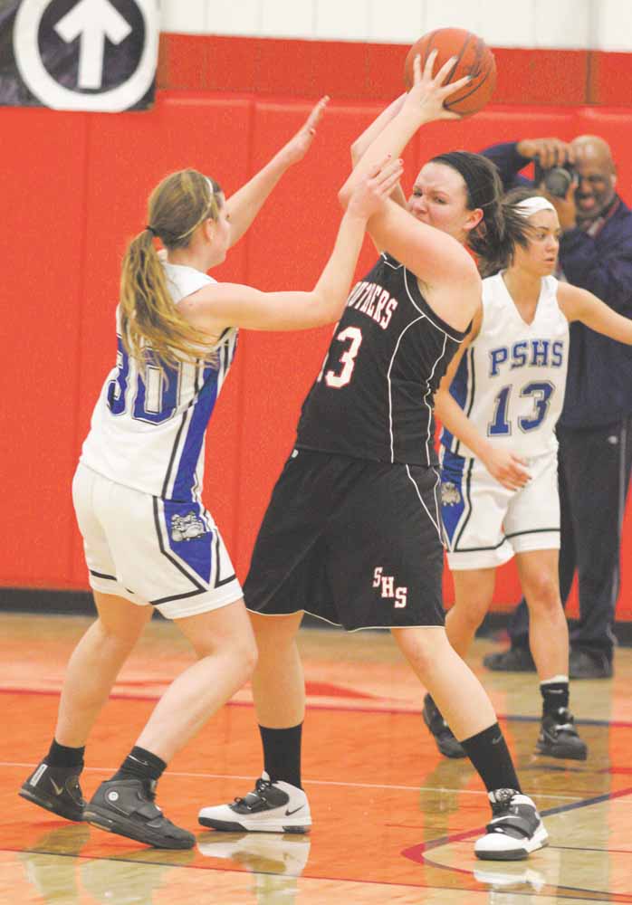 Stuthers' Hannah Dubec (13) is trapped by Maura Bobby (30) during their game Thursday night in Austintown.