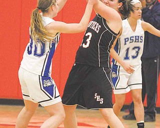 Stuthers' Hannah Dubec (13) is trapped by Maura Bobby (30) during their game Thursday night in Austintown.
